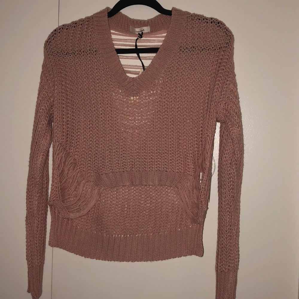 Cute light pink, ripped, cropped sweater.